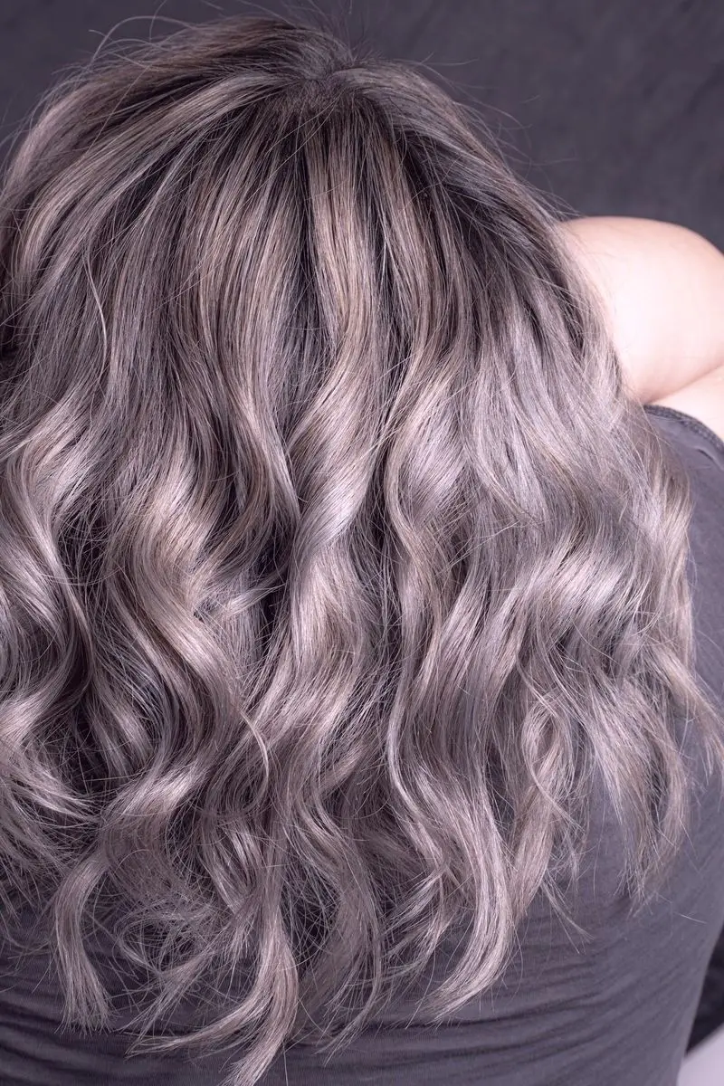 Waved hair lifted to a cool silver-lilac